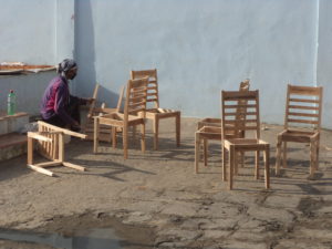 One female family member busy to making furniture