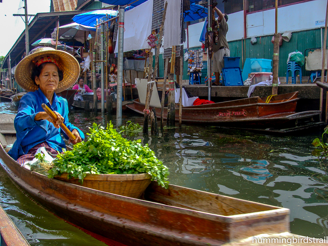 A lady in mo hom on her Sampan